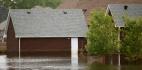 Flood waters rising beside a house
