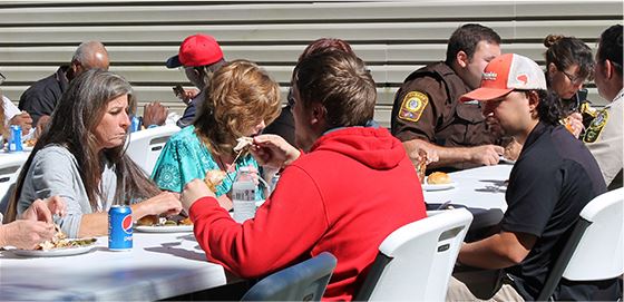 Citizens sitting together while eating lunch